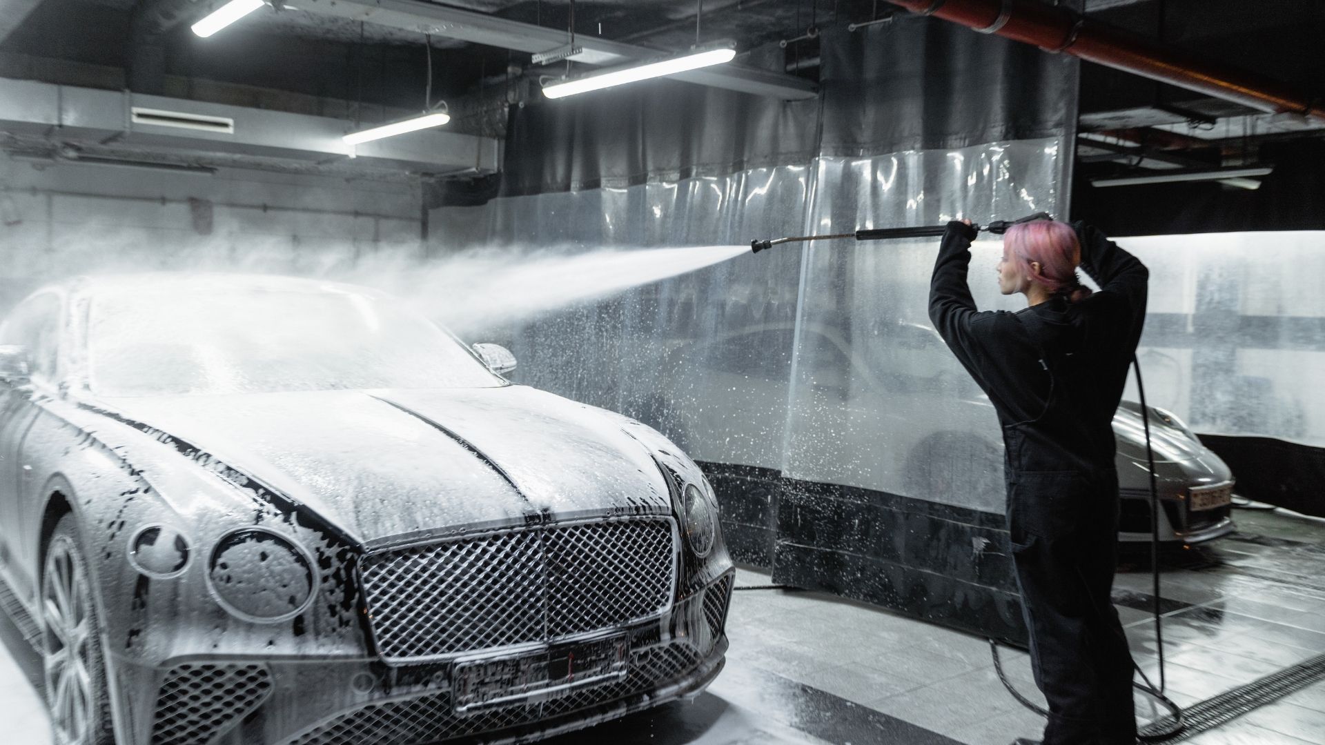 A woman washing a car