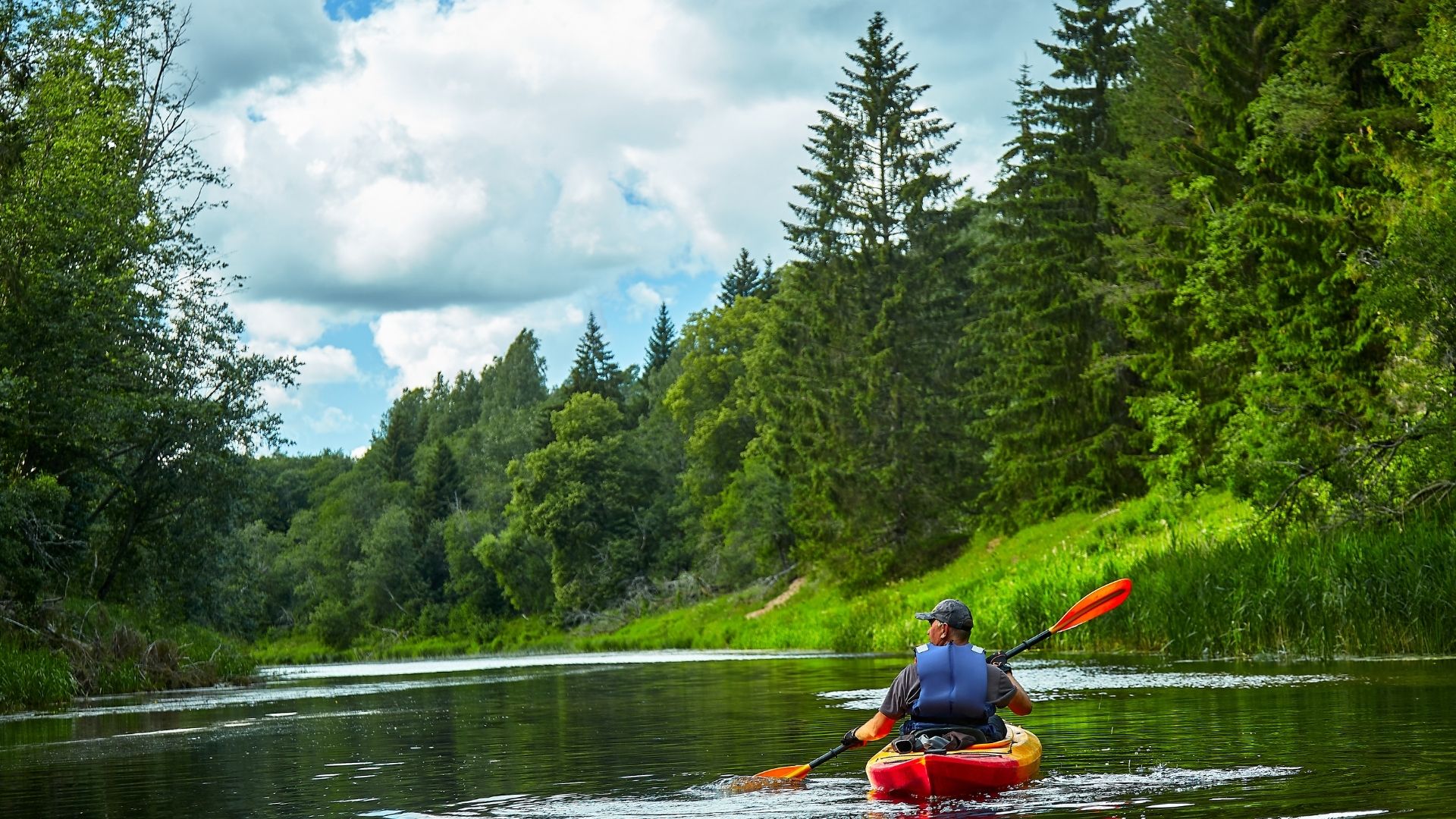 A kayaker paddling through a serene river, visualizing time management using the Kayaking Time Cost Calculator