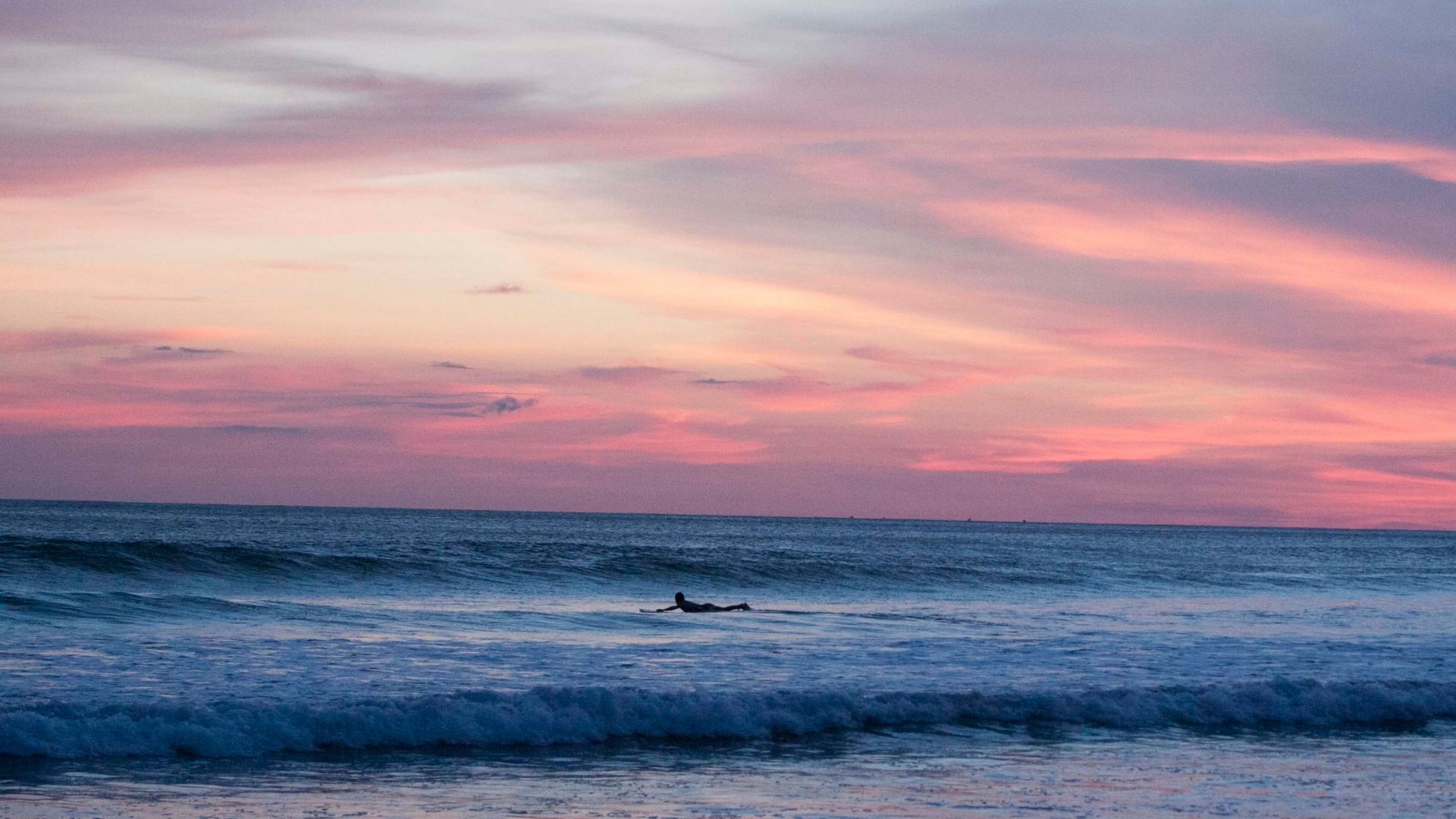 A surfer riding a perfect wave, managing time using the Surfing Time Cost Calculator